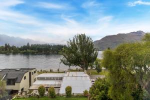 a building on the shore of a lake at Lodges 6 - Lake views and close to town in Queenstown