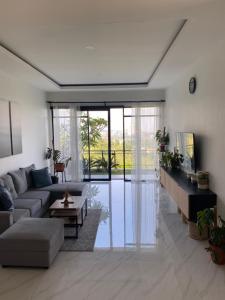 a living room with a couch and a table at Casa Revanaka Ciumbuleuit Bandung in Bandung
