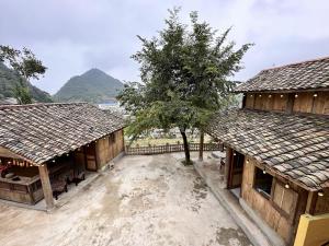 an aerial view of two buildings with a tree in the middle at HaPu Homestay Lô Lô Chải in Loung Co