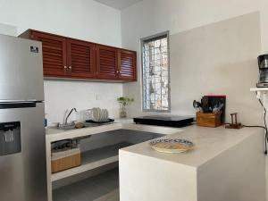 a kitchen with a refrigerator and a counter top at Casa Chaiik in Bacalar