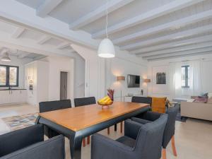 a dining room with a table and chairs at Seafront Villa Adriatica with pool in Dobropoljana