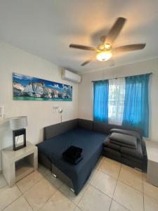 ein Wohnzimmer mit einer Couch und einem Deckenventilator in der Unterkunft Departamento Blue Vacacional in Playa del Carmen