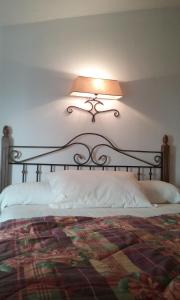 a bedroom with a bed with a lamp on the wall at Un balcón al Guadalquivir in Hornos