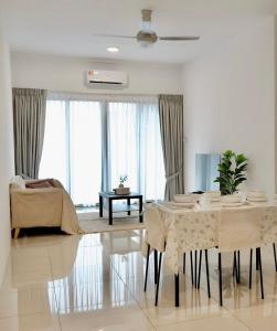 a living room with a table and a bed at Gem Suites Apartment in Kuching