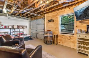 a living room with leather chairs and a room with wood at Mountain View, hot tub, fire pit, game room in Blairsville