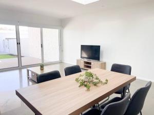 a conference room with a wooden table and chairs at Modern Central Retreat 1 in Wagga Wagga