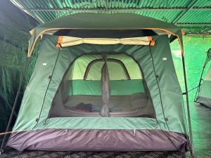 a green tent with the inside of it at Khaosok August Freedom Camp in Khao Sok