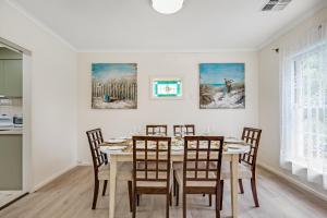 a dining room with a table and chairs at Jetty Road Retreat - Brighton - C21 SouthCoast Holidays in Brighton