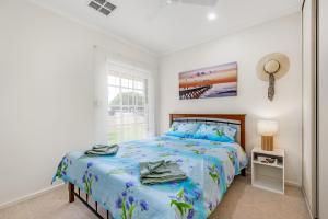 a bedroom with a bed and a window at Jetty Road Retreat - Brighton - C21 SouthCoast Holidays in Brighton +6 photos