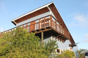 a house with a deck on the side of it at Casa San Juan in San Juan