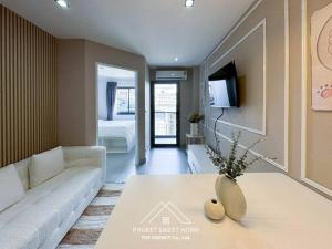 a living room with a couch and a table at Tower condo Rawai Phuket in Ban Klang +10 photos