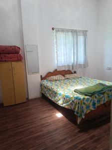 a bedroom with a bed and a window at Lilly Farm in Halgūr +15 photos