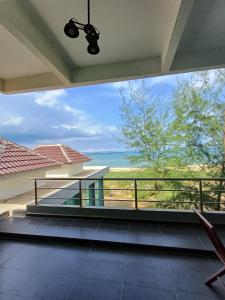 a view of the ocean from the balcony of a house at Mengkuang Villa, Penarik in Setiu