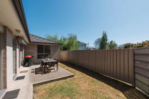 a backyard with a table and a fence at Gladstone at The Willows - Family Time, Mudgee Style in Mudgee