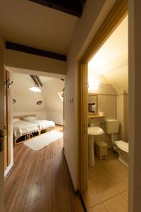 a bedroom with a bed and a tub and a sink at Pensiunea Bella Vita in Harghita-Băi