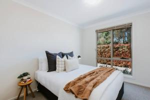 una camera bianca con un letto e una finestra di Denison at The Willows - Tranquil Country Retreat a Mudgee