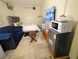 a living room with a couch and a microwave at Marvel Homes-Kivaa,Studio in Mavuria