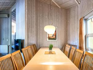 a dining room with a table and a potted plant at Strandblick - Dorf 1 Ferienhaus 02 in Priwall