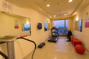 a hospital room with a treadmill and a gym at Ginger Chennai in Chennai