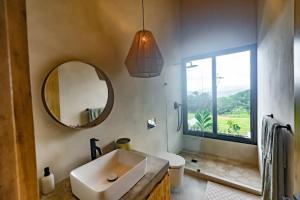 a bathroom with a sink and a mirror at The Oasis, Jungle Sanctuary in Barú