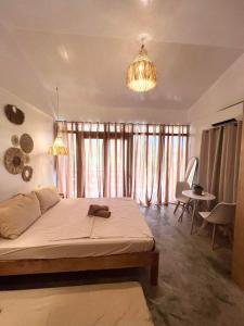 a bedroom with a bed and a chandelier at Dee Siargaonon Homestay in General Luna