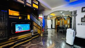 a living room with a flat screen tv on a wall at Chilanka Place HOME AWAY FROM HOME - Ernakulam- Kerala in Cochin