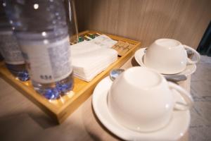 a table with plates and a bottle of water and cups at Resident Hotel Gogol in Almaty