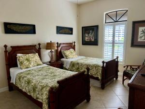 a bedroom with two beds and a window at Imperial Paradise Naples in Bonita Springs +19 photos
