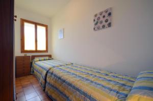 Łóżko lub łóżka w pokoju w obiekcie Villaggio Loriana