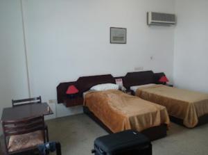 Postel nebo postele na pokoji v ubytování فندق ظفار Dhofar HOTEL