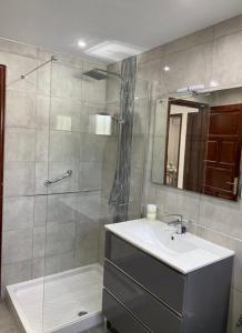 a bathroom with a shower and a sink and a mirror at Casa Terria in Tías