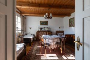 a room with a table and chairs and a bedroom at Przystań Czatachowa in Czatachowa