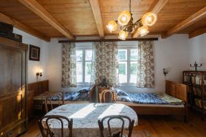 a room with three beds and a table and chairs at Przystań Czatachowa in Czatachowa