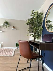 a office with a desk and a chair and a laptop at Serenity & Style With Parking in Lombard +2 photos