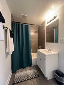 a bathroom with a shower curtain and a sink at Serenity & Style With Parking in Lombard