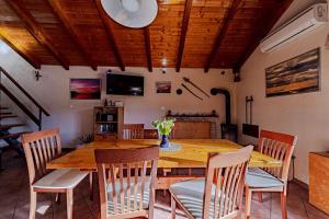 a dining room with a wooden table and chairs at Pool House Potirna - Happy Rentals in Blato