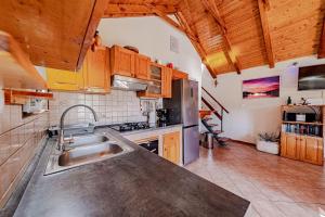 a kitchen with a stainless steel sink and wooden cabinets at Pool House Potirna - Happy Rentals in Blato