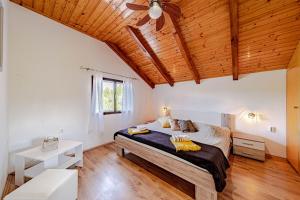 a bedroom with a bed and a wooden ceiling at Pool House Potirna - Happy Rentals in Blato +33 photos