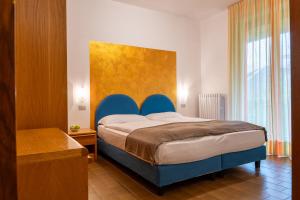 Ένα ή περισσότερα κρεβάτια σε δωμάτιο στο Hotel Costaverde "ai Roni"