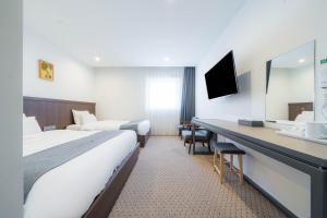 Postel nebo postele na pokoji v ubytování Davin Hotel