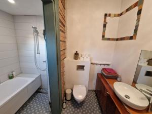 a bathroom with a sink and a toilet and a tub at Hillside view house with garden, private parking, quiet location - 12 min to Old town anytime, Long stays welcome in Vilnius +16 photos
