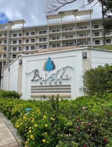 a building with a sign in front of a building at Serendipity Homestay Oakhill 514,Bristle Ridge Condominium, Baguio City in Baguio
