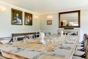 a long table with glasses and silverware on it at Oldfield house, walking distance of pub & sea in West Itchenor