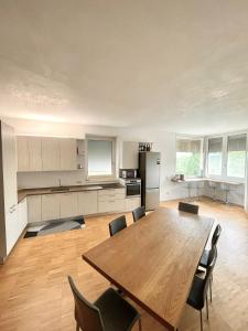 a large kitchen with a wooden table and chairs at Nuovo Progetto A&E in Vicenza