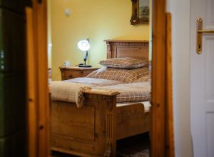 a bedroom with a bed with a lamp on it at Csengőd Kúria in Csengőd