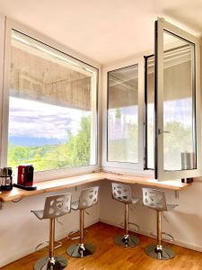 two windows in a kitchen with two chairs in front of them at Nuovo Progetto A&E in Vicenza
