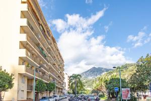 a city street with cars parked on the side of a building at Le landella in Menton