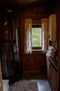 a bathroom with a shower and a window in a room at GapaLux in Levanger