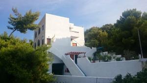 a white house with a staircase on the side of it at Agistri Island Dream in Skala
