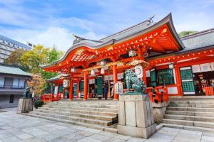 an orange temple with stairs in front of it at Hotel Piena Kobe in Kobe